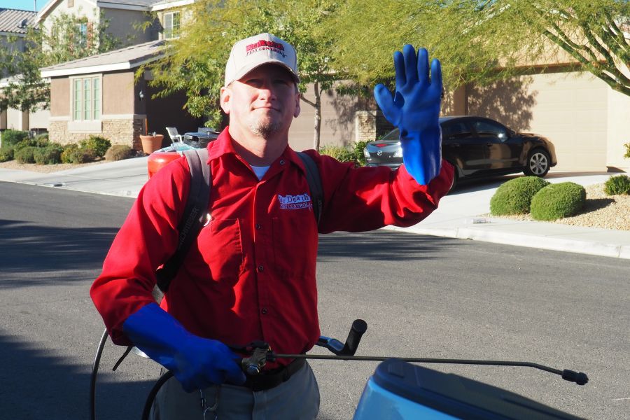 10 Questions to Ask When Choosing Professional Pest Control Services Pest control man waving.